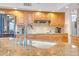 Updated kitchen with granite counters, stainless fridge, and wood cabinets at 6158 W Donald Dr, Glendale, AZ 85310