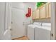 Functional laundry room with washer, dryer, and storage cabinets at 6158 W Donald Dr, Glendale, AZ 85310
