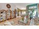 Open-concept living space with tile flooring, decorative shelving, and views into the dining area at 6158 W Donald Dr, Glendale, AZ 85310