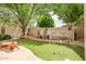 Backyard putting green with stone art features offering a fun and relaxing recreational area at 6158 W Donald Dr, Glendale, AZ 85310