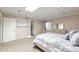 Bright bedroom featuring carpet, skylight, a modern bed frame, and access to the ensuite bathroom at 6240 N 16Th St # 45, Phoenix, AZ 85016
