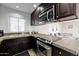 Well-equipped kitchen features dark cabinets, stainless steel appliances, and tiled countertops at 6240 N 16Th St # 45, Phoenix, AZ 85016