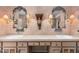 Elegant bathroom featuring dual sinks, decorative mirrors, and ornate sconces for a luxurious touch at 6301 N Camelback Manor Dr, Paradise Valley, AZ 85253