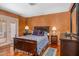 Cozy bedroom featuring warm tones, hardwood floors, and a comfortable bed with stylish decor at 6301 N Camelback Manor Dr, Paradise Valley, AZ 85253