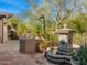 Inviting courtyard with stone fountain, desert plants, and decorative accents creates a tranquil outdoor space at 6301 N Camelback Manor Dr, Paradise Valley, AZ 85253
