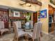 Cozy dining area features a stone fireplace, glass table, and comfortable striped chairs for a warm, inviting atmosphere at 6301 N Camelback Manor Dr, Paradise Valley, AZ 85253