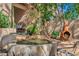Outdoor fountain surrounded by lush plants and stone patio offering a tranquil and inviting outdoor space at 6301 N Camelback Manor Dr, Paradise Valley, AZ 85253