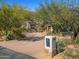 Well-maintained front yard featuring desert landscaping, mature trees, and a charming stone mailbox at 6301 N Camelback Manor Dr, Paradise Valley, AZ 85253