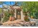 Enchanting garden entrance featuring a wooden gate, vibrant flowers, and lush greenery for a secluded escape at 6301 N Camelback Manor Dr, Paradise Valley, AZ 85253