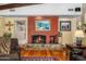 Cozy living room featuring a stone fireplace, hardwood floors, and comfortable seating at 6301 N Camelback Manor Dr, Paradise Valley, AZ 85253