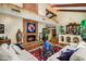 Bright living room features a fireplace, hardwood floors, vaulted ceilings, and stylish furnishings for a cozy ambiance at 6301 N Camelback Manor Dr, Paradise Valley, AZ 85253