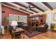 Comfortable living room with wood-beamed ceiling, hardwood floors, and large windows at 6301 N Camelback Manor Dr, Paradise Valley, AZ 85253