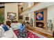 Spacious living room with a fireplace, hardwood floors, high ceilings, and elegant decor for a comfortable setting at 6301 N Camelback Manor Dr, Paradise Valley, AZ 85253