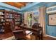 Home office with custom bookshelf, large desk and chair, and a bright window with outdoor views at 6301 N Camelback Manor Dr, Paradise Valley, AZ 85253