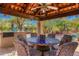 Charming outdoor dining area with tiled table, comfortable seating, and a covered patio for relaxing meals at 6301 N Camelback Manor Dr, Paradise Valley, AZ 85253