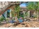 Inviting outdoor patio with dining set, lush greenery, and charming water feature for relaxation and enjoyment at 6301 N Camelback Manor Dr, Paradise Valley, AZ 85253