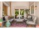 Cozy outdoor seating area with plush chairs, a stylish rug, and serene backyard views through French doors at 6301 N Camelback Manor Dr, Paradise Valley, AZ 85253