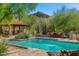 Stunning pool area with a mountain view, covered patio, lounge chairs, and desert landscaping at 6301 N Camelback Manor Dr, Paradise Valley, AZ 85253