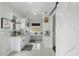 Bright bathroom with double vanities, marble counters, and a standalone tub under a window at 6340 E Mitchell Dr, Scottsdale, AZ 85251