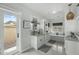 Bright bathroom featuring double sinks, white cabinets, and access to the outdoors at 6340 E Mitchell Dr, Scottsdale, AZ 85251