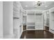Spacious walk-in closet with custom shelving, drawers, and hardwood flooring at 6340 E Mitchell Dr, Scottsdale, AZ 85251