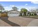 This inviting single-story home features a charming white exterior and a spacious brick driveway at 6340 E Mitchell Dr, Scottsdale, AZ 85251