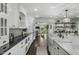 Spacious kitchen featuring white cabinets, dark countertops, a large island, and stainless steel appliances at 6340 E Mitchell Dr, Scottsdale, AZ 85251