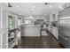 Spacious kitchen featuring white cabinets, a large island, and stainless steel appliances at 6340 E Mitchell Dr, Scottsdale, AZ 85251
