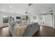 Spacious living room with hardwood floors, a large grey sectional, and backyard access at 6340 E Mitchell Dr, Scottsdale, AZ 85251