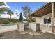 Backyard featuring pool, outdoor kitchen with stainless grill, covered patio, and lush landscaping at 6340 E Mitchell Dr, Scottsdale, AZ 85251