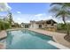 Expansive backyard featuring a sparkling pool, covered patio, outdoor kitchen, and lush landscaping for luxurious outdoor living at 6340 E Mitchell Dr, Scottsdale, AZ 85251