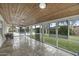 Enclosed sun room with wood ceiling, tile flooring and glass windows with views to the exterior at 6340 E Mitchell Dr, Scottsdale, AZ 85251
