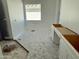 Bright bathroom with a window and white cabinets being installed, offering functionality and style at 6460 E Omega Cir, Mesa, AZ 85215
