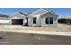 Charming new construction home featuring bright white siding and a spacious two car garage at 6460 E Omega Cir, Mesa, AZ 85215