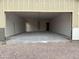 A spacious garage featuring a smooth concrete floor and drywall that is ready for paint and finish at 6460 E Omega Cir, Mesa, AZ 85215
