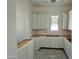 Bright, airy kitchen showcasing modern white cabinets being installed and natural light at 6460 E Omega Cir, Mesa, AZ 85215