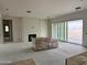 An unfinished living room shows a fireplace, big sliding glass doors, and a view to the backyard at 6460 E Omega Cir, Mesa, AZ 85215