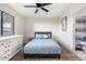 Comfortable bedroom features a ceiling fan, neutral walls, and a view into the bathroom at 7110 E Continental Dr # 1044, Scottsdale, AZ 85257