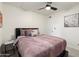 Clean bedroom with neutral walls, ceiling fan and modern art at 7110 E Continental Dr # 1044, Scottsdale, AZ 85257