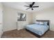 Cozy bedroom with a ceiling fan, neutral walls, and a large window for natural light at 7110 E Continental Dr # 1044, Scottsdale, AZ 85257