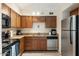 Functional kitchen with stainless steel appliances, wood cabinets, and ample counter space at 7110 E Continental Dr # 1044, Scottsdale, AZ 85257