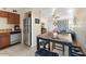 Open kitchen with stainless steel appliances, a dining table, and a view into the living room at 7110 E Continental Dr # 1044, Scottsdale, AZ 85257