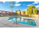Inviting community pool surrounded by lush landscaping and well-maintained buildings at 7110 E Continental Dr # 1044, Scottsdale, AZ 85257