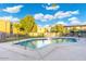 Serene community pool offering a refreshing escape with palm trees and blue skies at 7110 E Continental Dr # 1044, Scottsdale, AZ 85257