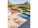 Aerial view of the backyard showcasing a swimming pool, tennis court, lounge chairs, and landscaped grounds at 7630 E Vaquero Dr, Scottsdale, AZ 85258