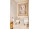 Elegant bathroom with a bidet, toilet, and a framed classical painting at 7630 E Vaquero Dr, Scottsdale, AZ 85258