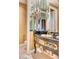 Ornate bathroom featuring a dark granite countertop vanity with golden accents and a mirrored wall at 7630 E Vaquero Dr, Scottsdale, AZ 85258