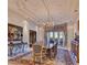 Formal dining room featuring ornate chandelier, area rug, with large picture window at 7630 E Vaquero Dr, Scottsdale, AZ 85258
