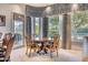 Elegant dining area featuring a round table, detailed chairs, and large windows with patterned valances at 7630 E Vaquero Dr, Scottsdale, AZ 85258