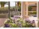 Exterior detail of columns, showcasing lush landscaping and white & purple flowers at 7630 E Vaquero Dr, Scottsdale, AZ 85258